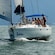 A sailboat carries several passengers in the ocean